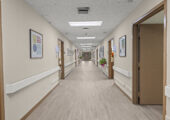 Facility hallway with resident rooms on both sides.