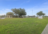 Outdoor photo of Riverside Oaks facility from the back lawn.